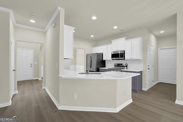 6341 Stewart Ridge Walk, Buford, GA 30518 - kitchen featuring stainless steel appliances, wood finished floors, white cabinets, tasteful backsplash, and light countertops