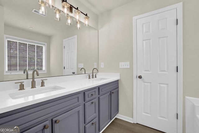 6341 Stewart Ridge Walk, Buford, GA 30518 - bathroom featuring double vanity, wood finished floors, and baseboards
