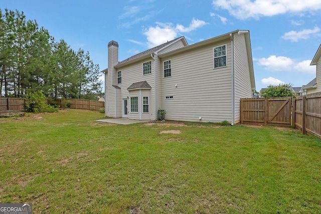 6341 Stewart Ridge Walk, Buford, GA 30518 - back of property with a chimney, a gate, and a patio