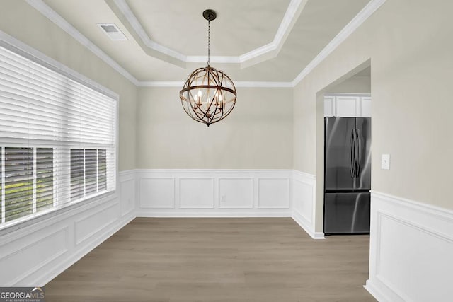6341 Stewart Ridge Walk, Buford, GA 30518 - unfurnished dining area with a raised ceiling, a chandelier, light wood-style floors, wainscoting, and a decorative wall