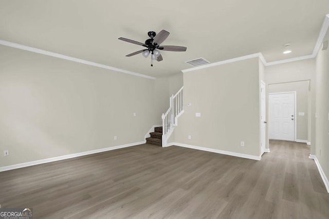 6341 Stewart Ridge Walk, Buford, GA 30518 - unfurnished living room with stairway, ceiling fan, wood finished floors, baseboards, and crown molding