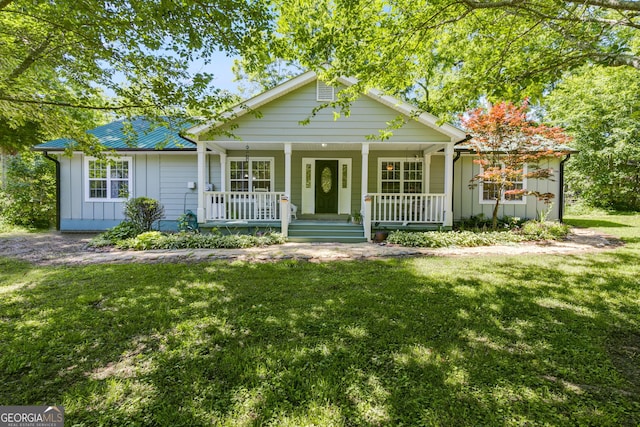 103 Depot St, Buchanan, GA 30113 - view of front of home featuring board and batten siding, a porch, and a front lawn