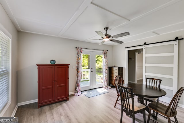 103 Depot St, Buchanan, GA 30113 - dining room with a barn door, french doors, light wood-type flooring, a ceiling fan, and baseboards