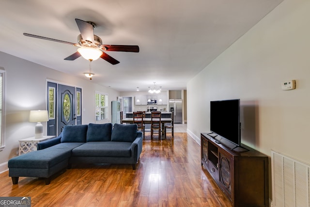 103 Depot St, Buchanan, GA 30113 - living room featuring wood-type flooring, ceiling fan, a chandelier, and baseboards