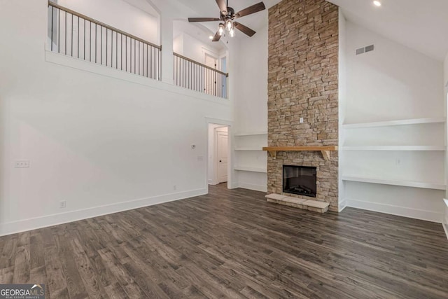 4075 O Henry Ct, Mcdonough, GA 30252 - unfurnished living room with high vaulted ceiling, ceiling fan, a fireplace, dark wood-style flooring, and built in features