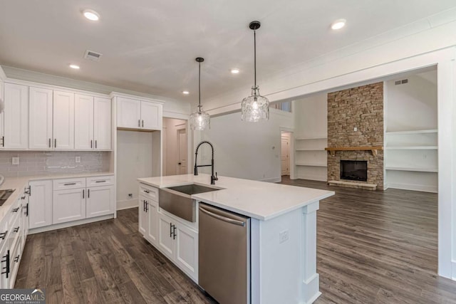 4075 O Henry Ct, Mcdonough, GA 30252 - kitchen featuring stainless steel dishwasher, white cabinets, dark wood-style flooring, light countertops, and a center island with sink