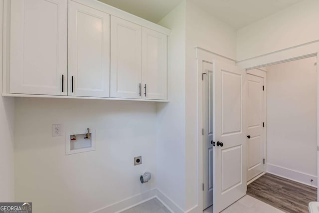 4075 O Henry Ct, Mcdonough, GA 30252 - washroom featuring hookup for an electric dryer, hookup for a washing machine, cabinet space, and wood finished floors