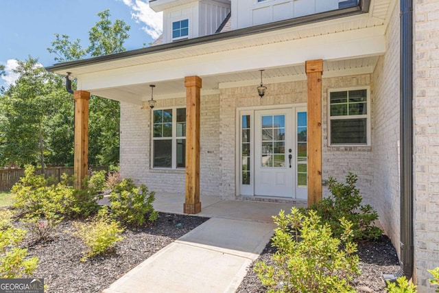 4075 O Henry Ct, Mcdonough, GA 30252 - doorway to property with brick siding, a porch, and board and batten siding
