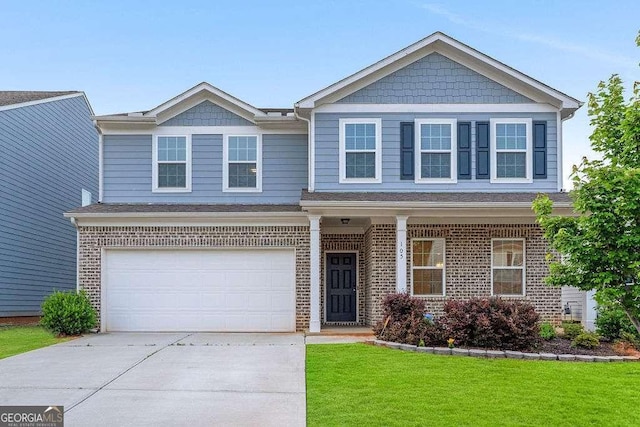105 Paulowina Cir, Mcdonough, GA 30253 - view of front of home featuring driveway, a front yard, a garage, and brick siding