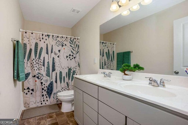 105 Paulowina Cir, Mcdonough, GA 30253 - bathroom featuring toilet, double vanity, and a shower with shower curtain