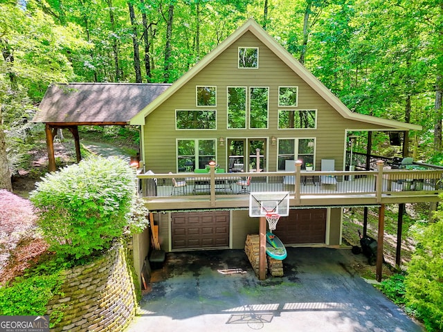 177 Whitetail Trl, Clayton, GA 30525 - view of front facade with a garage, driveway, a view of trees, and a wooden deck