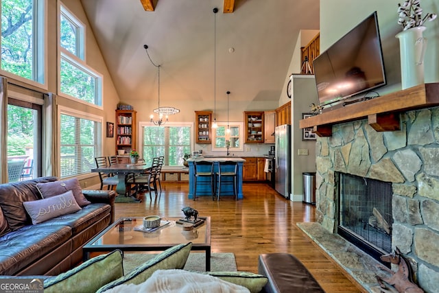 177 Whitetail Trl, Clayton, GA 30525 - living room with high vaulted ceiling, a chandelier, dark wood-style floors, and a stone fireplace