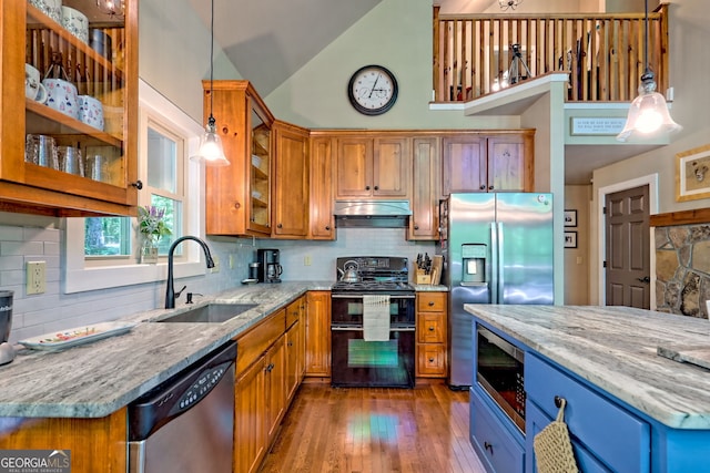 177 Whitetail Trl, Clayton, GA 30525 - kitchen with a sink, appliances with stainless steel finishes, brown cabinetry, light stone counters, and lofted ceiling
