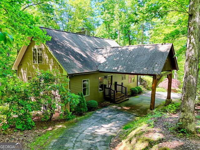 177 Whitetail Trl, Clayton, GA 30525 - view of front of home with asphalt driveway, a chimney, and a shingled roof