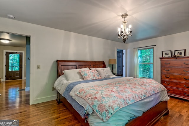 177 Whitetail Trl, Clayton, GA 30525 - bedroom featuring wood finished floors, a chandelier, and baseboards