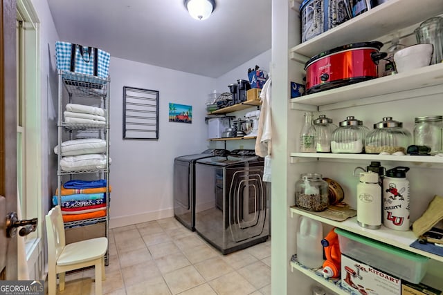 177 Whitetail Trl, Clayton, GA 30525 - laundry area featuring washing machine and clothes dryer, tile patterned floors, and baseboards