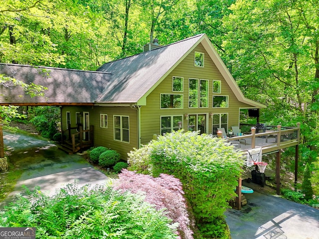 177 Whitetail Trl, Clayton, GA 30525 - back of house featuring driveway, a chimney, a deck, a shingled roof, and a forest view