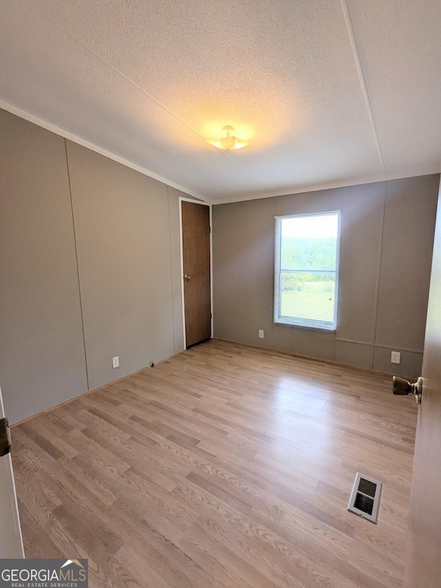 1096 Tesnatee Gap Valley Rd, Cleveland, GA 30528 - unfurnished bedroom featuring wood finished floors and a textured ceiling