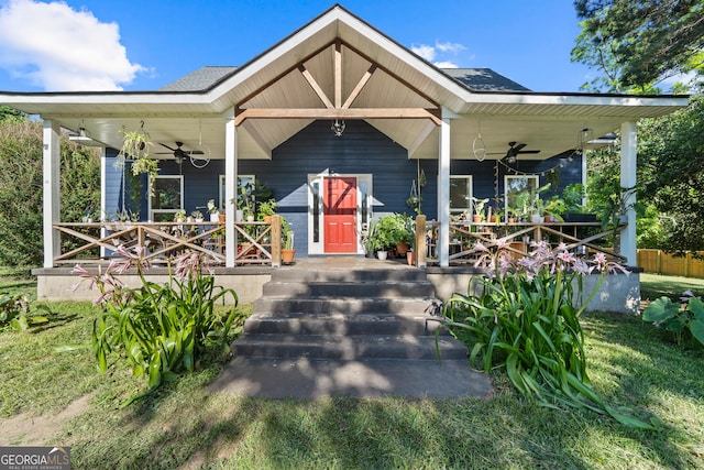 7170 Church St, Bartow, GA 30413 - view of front of house with a ceiling fan, covered porch, and a front lawn
