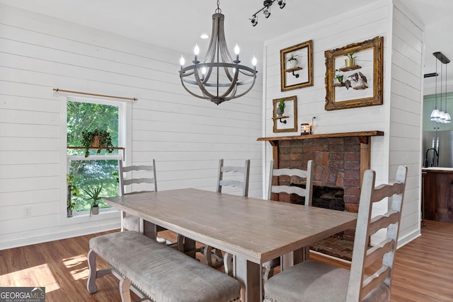 7170 Church St, Bartow, GA 30413 - dining space with a chandelier, wood walls, wood finished floors, and baseboards