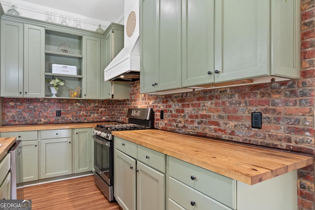 7170 Church St, Bartow, GA 30413 - kitchen featuring butcher block counters, green cabinets, stainless steel range with gas stovetop, open shelves, and custom range hood