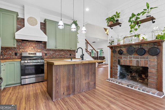 7170 Church St, Bartow, GA 30413 - kitchen featuring stainless steel gas range oven, green cabinetry, butcher block counters, a sink, and recessed lighting