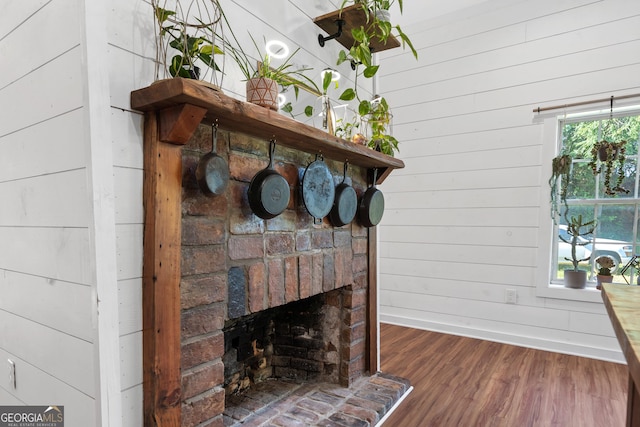 7170 Church St, Bartow, GA 30413 - detailed view of wooden walls, wood finished floors, a fireplace, and baseboards