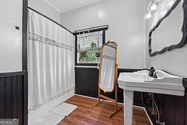 7170 Church St, Bartow, GA 30413 - bathroom featuring wainscoting, wood finished floors, ornamental molding, and shower / bath combination with curtain