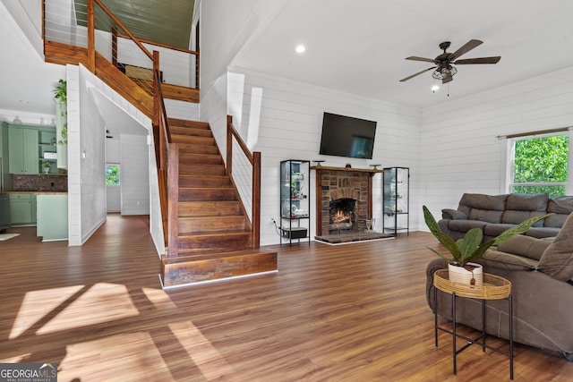 7170 Church St, Bartow, GA 30413 - living room with wood finished floors, stairway, a ceiling fan, wood walls, and recessed lighting