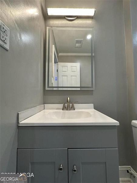 5711 Sterling Pl, Macon, GA 31206 - bathroom featuring crown molding, vanity, and toilet