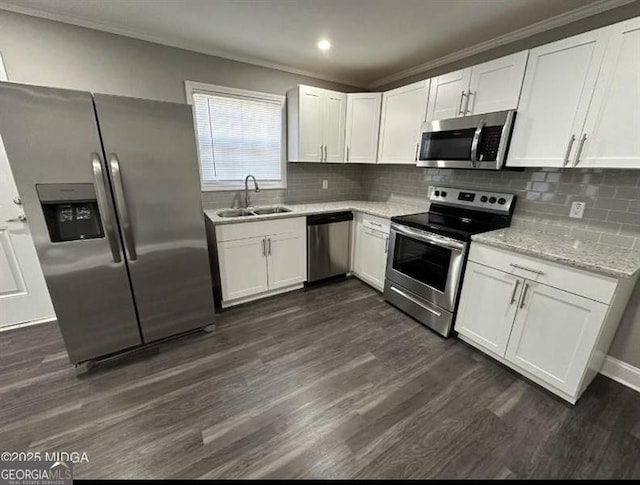 5711 Sterling Pl, Macon, GA 31206 - kitchen featuring stainless steel appliances, a sink, dark wood-type flooring, white cabinetry, and ornamental molding