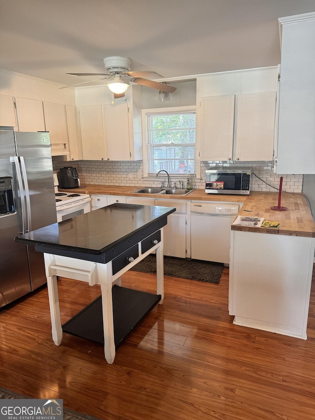 206 Audubon Way, Warner Robins, GA 31088 - kitchen with a sink, appliances with stainless steel finishes, white cabinets, and decorative backsplash