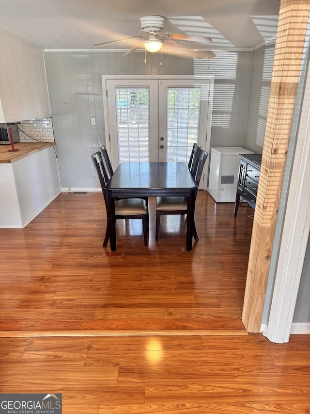 206 Audubon Way, Warner Robins, GA 31088 - dining space with french doors, a ceiling fan, light wood finished floors, and ornamental molding