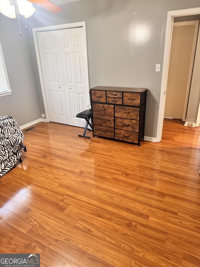 206 Audubon Way, Warner Robins, GA 31088 - bedroom featuring wood finished floors, a closet, baseboards, and ceiling fan