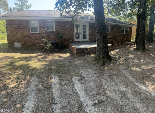 206 Audubon Way, Warner Robins, GA 31088 - back of house with french doors, brick siding, central AC, and a patio