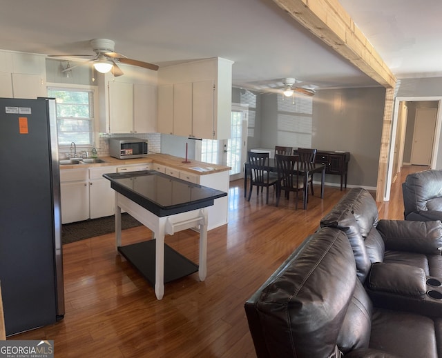 206 Audubon Way, Warner Robins, GA 31088 - kitchen featuring appliances with stainless steel finishes, ceiling fan, open floor plan, and dark wood finished floors