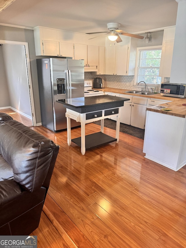 206 Audubon Way, Warner Robins, GA 31088 - kitchen with appliances with stainless steel finishes, a sink, ceiling fan, white cabinetry, and decorative backsplash