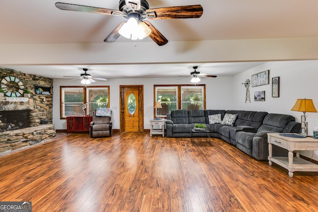 894 Lake Circle Rd, Buchanan, GA 30113 - living room featuring a ceiling fan, wood finished floors, and a stone fireplace