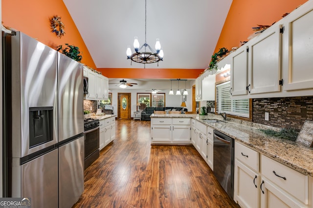 894 Lake Circle Rd, Buchanan, GA 30113 - kitchen featuring stainless steel fridge, black dishwasher, open floor plan, range with gas stovetop, and a peninsula