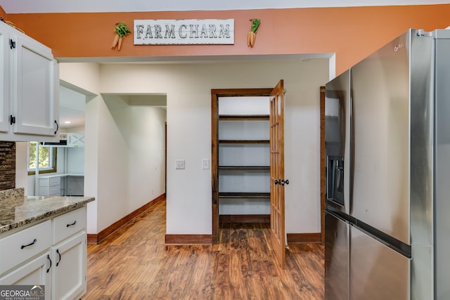 894 Lake Circle Rd, Buchanan, GA 30113 - kitchen with stainless steel refrigerator with ice dispenser, white cabinetry, dark wood-type flooring, and baseboards