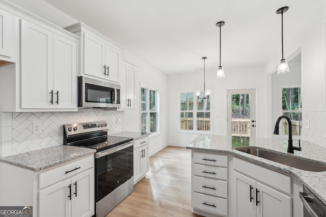 2279 Lakeview Pkwy, Villa Rica, GA 30180 - kitchen with appliances with stainless steel finishes, a sink, tasteful backsplash, and light wood-style floors