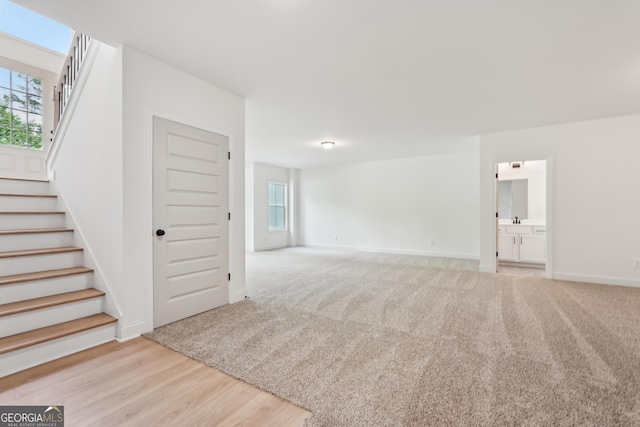 2279 Lakeview Pkwy, Villa Rica, GA 30180 - unfurnished living room with stairway, plenty of natural light, and baseboards