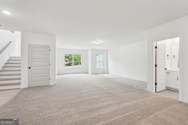 2279 Lakeview Pkwy, Villa Rica, GA 30180 - unfurnished living room with carpet flooring, stairway, baseboards, and recessed lighting