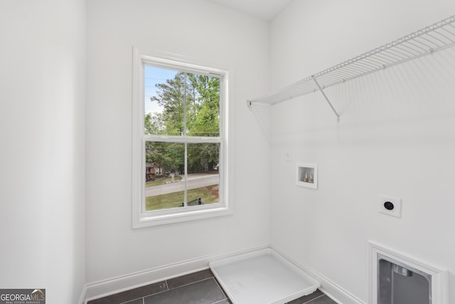 2279 Lakeview Pkwy, Villa Rica, GA 30180 - laundry room with electric dryer hookup, washer hookup, dark tile patterned flooring, and baseboards
