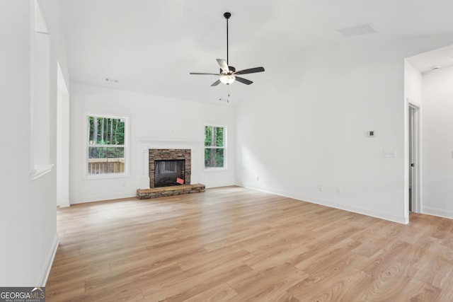 2279 Lakeview Pkwy, Villa Rica, GA 30180 - unfurnished living room with a ceiling fan, light wood-type flooring, lofted ceiling, a stone fireplace, and baseboards