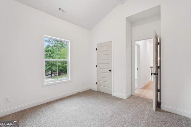 2279 Lakeview Pkwy, Villa Rica, GA 30180 - unfurnished bedroom featuring light colored carpet, lofted ceiling, and baseboards