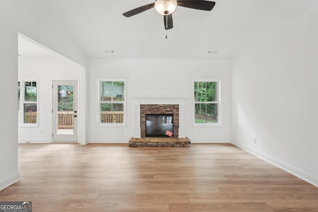 2279 Lakeview Pkwy, Villa Rica, GA 30180 - unfurnished living room featuring lofted ceiling, ceiling fan, light wood-style flooring, a fireplace, and baseboards