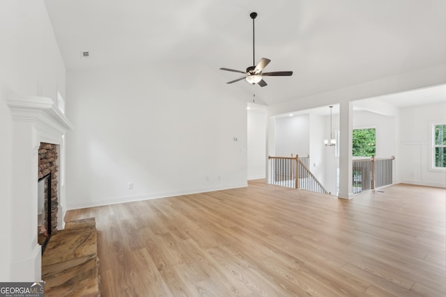 2279 Lakeview Pkwy, Villa Rica, GA 30180 - unfurnished living room featuring a ceiling fan, light wood-style flooring, a fireplace, high vaulted ceiling, and baseboards