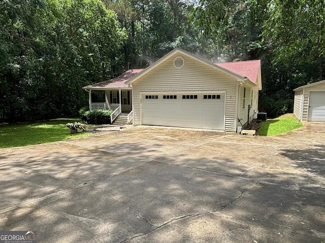161 Cedar Cove Dr, Buckhead, GA 30625 - view of front facade featuring driveway, central AC unit, a porch, a garage, and a front lawn