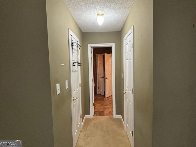 161 Cedar Cove Dr, Buckhead, GA 30625 - hallway with light colored carpet, a textured ceiling, and baseboards